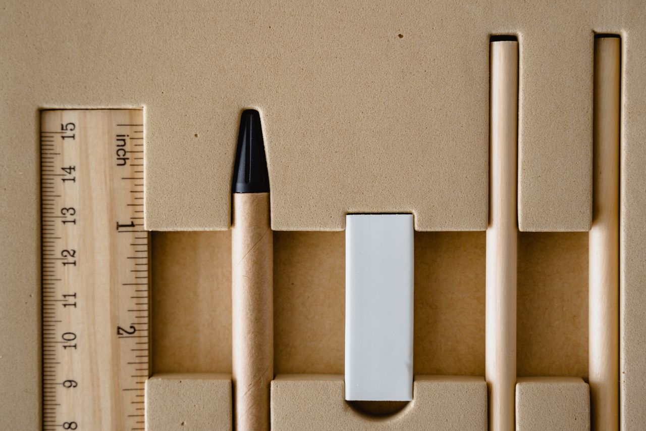 Top view of neatly organized school supplies, including ruler, pencil, and eraser.